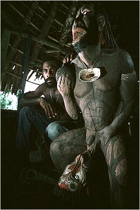 Master carver with his work, Torembai, Sepik River, Papua New Guinea. copyright Michael McCoy