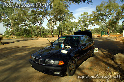 A break from the endless highway to clean the splattered bugs off the windscreen and to top up the fuel from a jerry can. Driving into the sun from here and so a cleen screen makes a huge difference.  Photo copyright Peter Andrews, Outimage Australia.