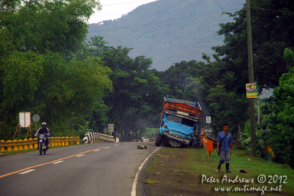 A truck with a broken axel along the highway to Kidapawan City, Davao del Sur Province, Mindanao, Philippines. Photo copyright Peter Andrews, Outimage Australia.