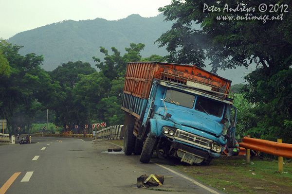 A truck with a broken axel along the highway to Kidapawan City, Davao del Sur Province, Mindanao, Philippines. Photo copyright Peter Andrews, Outimage Australia.