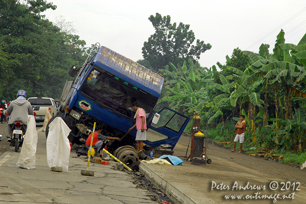 Another trucking disaster at a roadworks site along the highway to Kidapawan City, Davao del Sur Province, Mindanao, Philippines. Photo copyright Peter Andrews, Outimage Australia.