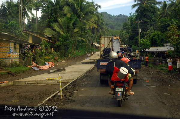 The roadworks continues along the highway to Kidapawan City, Cotabato Province, Mindanao, Philippines. Photo copyright Peter Andrews, Outimage Australia.