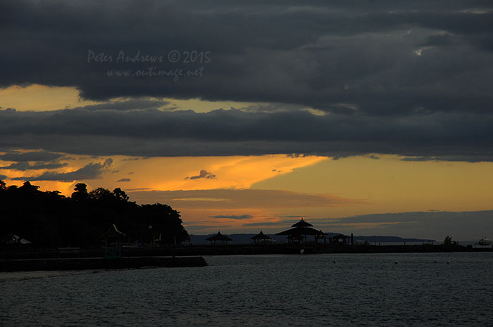 Evening storm clouds building up over the mountains surrounding Davao City, Mindanao, seen from Paradise Island Beach on Samal Island.