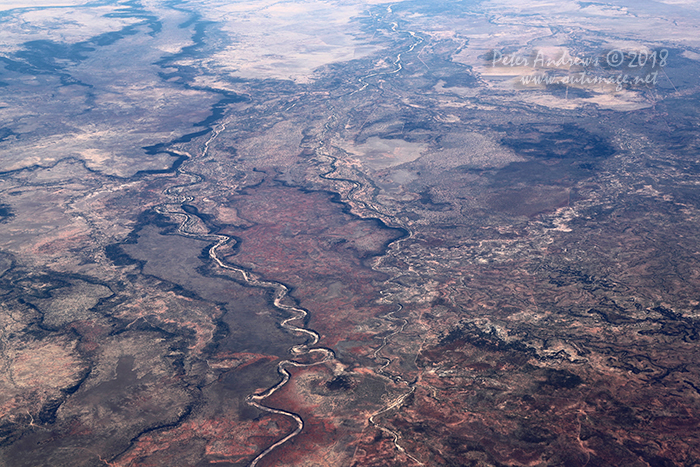 The dry Dutton River winds its way towards Richmond in outback Queensland, from the high plateu landscape near Porcupine Gorge. 20°15'26.0"S 143°52'34.6"E. High altitude shots from a flight between Sydney Australia and Manila, Philippines.