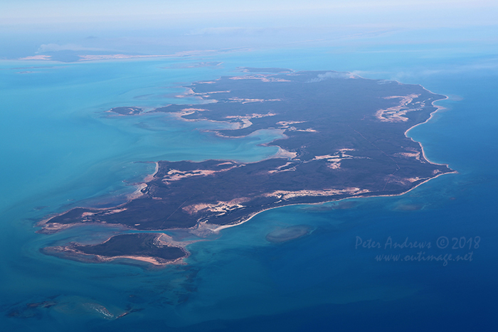 Fires burning on Morington Island in the Gulf of Carpentaria and on the mainlane in the background, near Burketown in outback Queensland. 16°19'14.7"S 139°48'23.4"E. High altitude shots from a flight between Sydney Australia and Manila, Philippines.