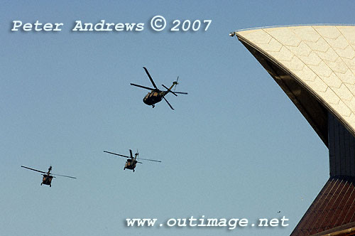 Australian Army Black Hawks patrolling Sydney Harbour just flying behind the front shell of the Sydney Opera House.