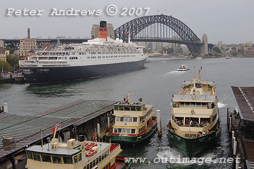 Commuter ferries at Circular Quay, the QE2 and the Sydney Harbour Bridge.