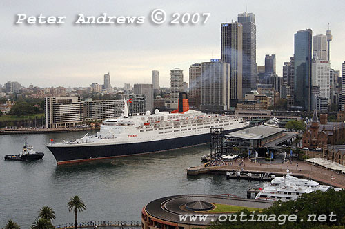 QE2 departing Circular Quay with the Sydney skyline in the background.