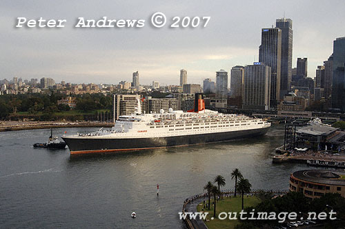 QE2 departing Circular Quay with the Sydney skyline in the background.