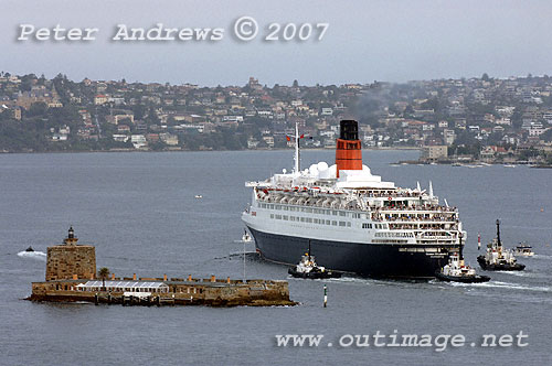 QE2 passes Sydney's Fort Denison, the third tug escort is the Wonga from Sydney.