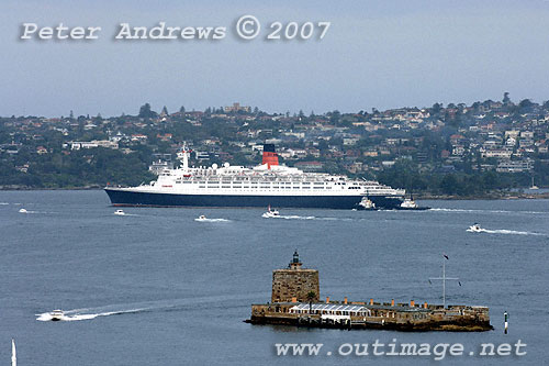 QE2 rounds Bradleys Head with Shark Island and Vaucluse in the background.
