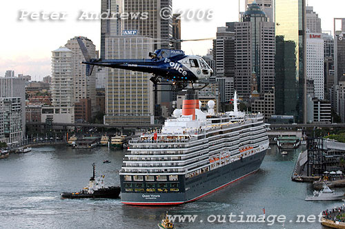 The Queen Victoria arrives at the Overseas Passenger Terminal at Circular Quay as a Police helicoptor passes by.