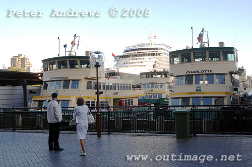 The Queen Victoria towers above four of Sydney's First Fleet Class passenger ferries at the Circular Quay.