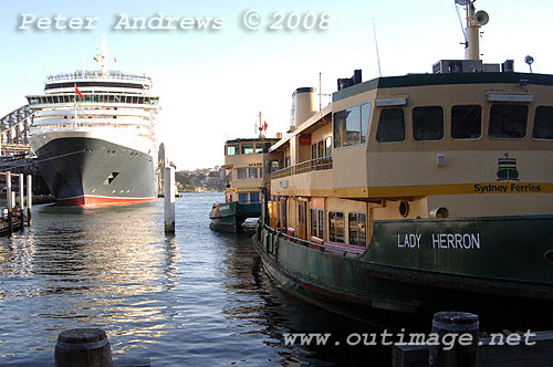 One of the few remaining Lady Class ferries in the forground at Circular Quay with the new Queen Victoria in the background.