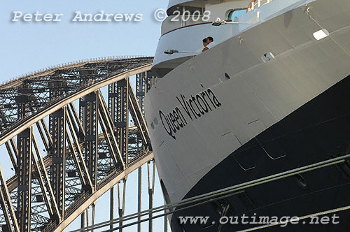 Crew on the bow of the Queen Mary reflecting on their arrival in Sydney with the Harbour Bridge in the background.
