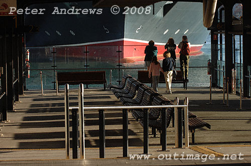 Locals reflecting on the size of the bow of the Queen Victoria from Wharf 6, Circular Quay.