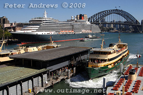 A Manly ferry arrives at Wharf 3 Circular Quay with the Queen Victoria and the Harbour Bridge in the background.