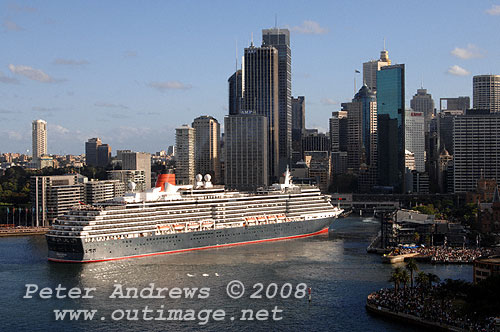 Queen Victoria slips astern out of Circular Quay with the Sydney city skyline in the background.