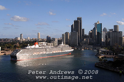 Queen Victoria slips astern out of Circular Quay with the Sydney city skyline in the background.