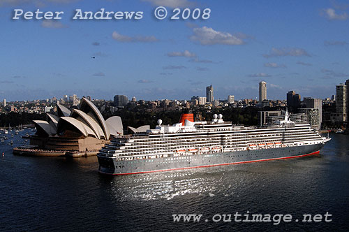 Queen Victoria slips astern out of Circular Quay past the Sydney Opera House.
