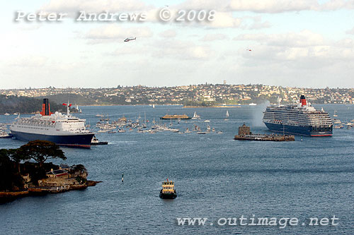 The two Cunard Queens' salute each other by sounding their horns.
