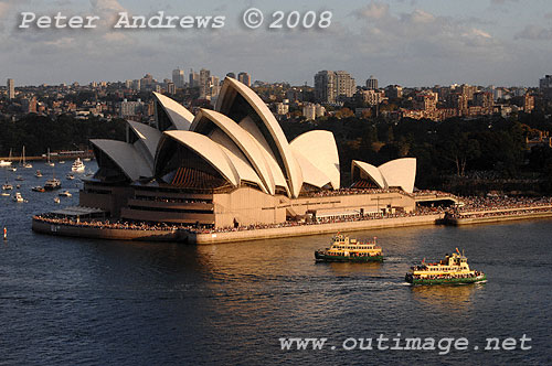 Two First Fleet Class ferries cross paths off the Sydney Opera House in Circular Quay.
