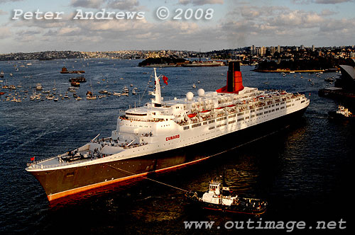 Queen Elizabeth II being positioned by tugs to go astern into Circular Quay.