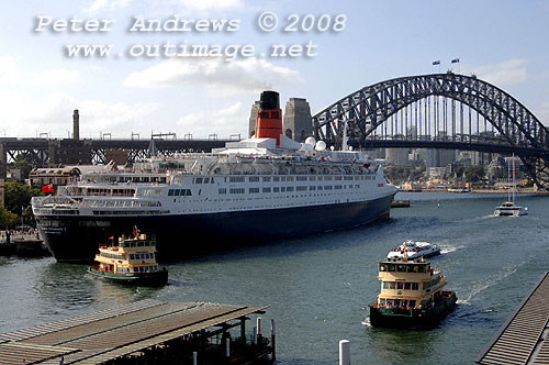 Queen Elizabeth 2 with 2 First Fleet Class passenger ferries at at work in Circular Quay Sydney.