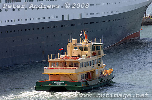 The First Fleet Class passenger ferry Friendship slips past the Queen Elizabeth 2, Circular Quay Sydney.