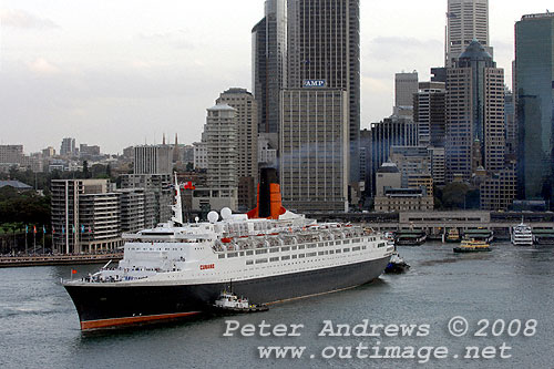 Queen Elizabeth 2 leaving Circular Quay Sydney with the city in the background.