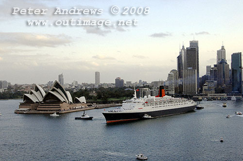 Queen Elizabeth 2 leaving Circular Quay with the Sydney Opera House and the city skyline in the background.