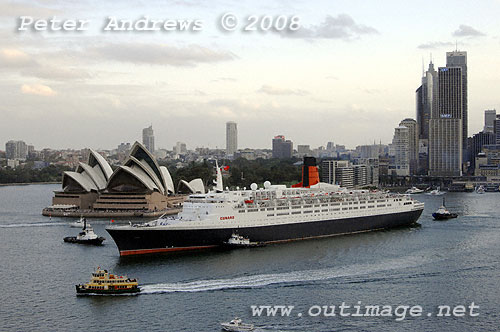 Queen Elizabeth 2 leaving Circular Quay with the Sydney Opera House and the city skyline in the background.