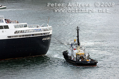 The stern of Queen Elizabeth 2 being swung by a tug to clear Circular Quay for passage out of Sydney Harbour.