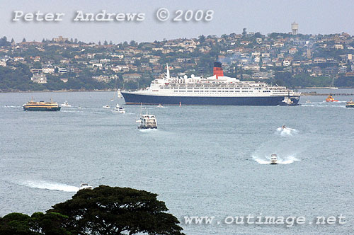 Queen Elizabeth 2 on Sydney Harbour with Vaucluse in the background.