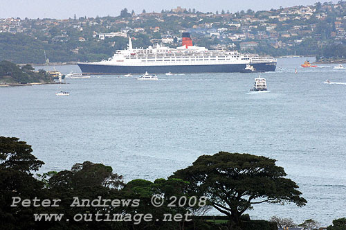 Queen Elizabeth 2 about to slip past Bradleys Point on Sydney Harbour.
