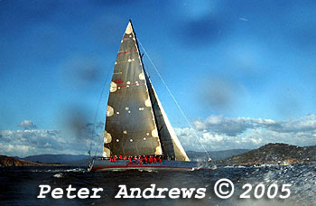 Wild Oats XI in 2005, smashing the race record previously held by Nokia in 1999. This shot was taken just before just before the experience problems with the top batten of the mainsail blowing out. Looking side on and a little behind the boat with a view looking up the river, the image of the boat is surrounded by out of focus droplets of water on the surface of the camera lens.
