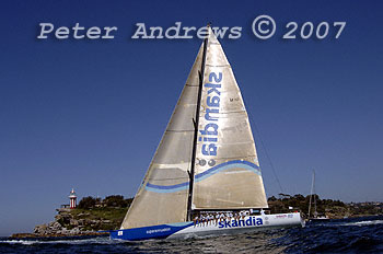 Skandia sailing down the back of a rolling swell past South Head of Sydney Harbour on a sunny Winter day, sailing out into the Tasman Sea for the 2007 Audi Sydney to Southport Yacht Race.