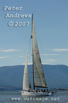 Roger Sturgeon's Rosebud gets moving after being becalmed just outside the mouth of the Derwent River. With Tasmanian bowman Justin Clougher aloft, the boat is seen here with Mount Wellington in the Background.
