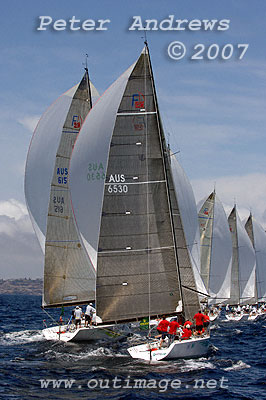 A line of Farr 40's under spinnaker just after rounding the