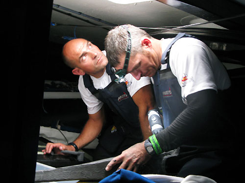 Xabier Fernandez left and Pepe Ribes attempt to repair steering damage to Telefonica Blue which occured shortly after the start of leg 1. Photo copyright Gabriele Olivo - Equipo Telefonica.