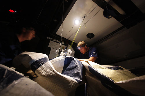 Skipper Anders Lewander and Martin Stromberg repair Ericsson 3's jib below decks. The jib got caught on the radar, ripping the sail and bringing the radar down during a tack shortly after they crossed the start line on leg 2 from Cape Town, South Africa to Cochin, India. Photo copyright Gustav Morin / Ericsson 3 / Volvo Ocean Race.