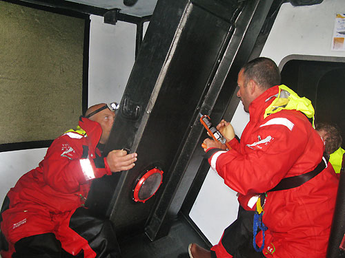 Tom Braidwood and Damian Foxall repair a leaking daggerboard case onboard Green Dragon, on leg 2 of the Volvo Ocean Race, from Cape Town, South Africa to Cochin, India. Photo copyright Guo Chuan / Green Dragon Racing / Volvo Ocean Race.