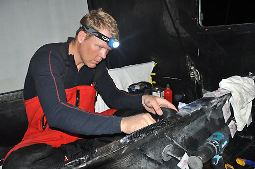 Caey Smith from Australia makes final repairs to the bow. The crew of PUMA Ocean Racing make repairs to their boat after sustaining serious structural damage in rough seas, for the second time in 24 hours. Photo  Rick Deppe / PUMA Ocean Racing / Volvo Ocean Race.