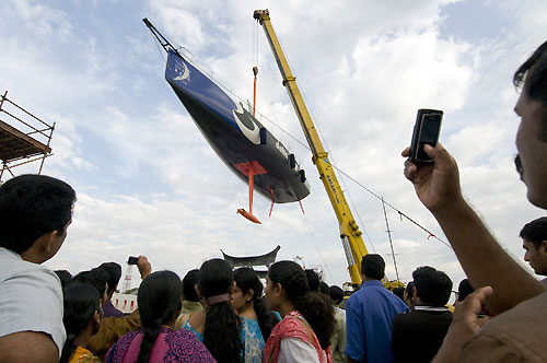 Crowds watch as Delta Lloyd is lifted from the water in Cochin, India. Photo copyright Dave Kneale / Volvo Ocean Race.