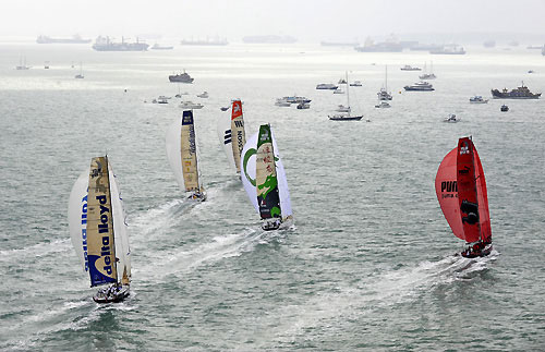 The fleet of Volvo Open 70's battle around the short course during the Singapore In-Port Racing. In the background are some of the vast number of ships anchored outside this busy global maritime crossroad. Photo copyright Rick Tomlinson / Volvo Ocean Race.
