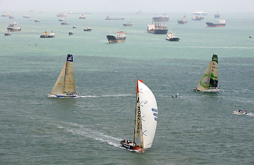 The fleet of Volvo Open 70's battle around the short course during the Singapore In-Port Racing. In the background are some of the vast number of ships anchored outside this busy global maritime crossroad. Photo copyright Rick Tomlinson / Volvo Ocean Race.