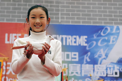 A young Chinese girl holding one of a number of Doves to be released on Start Day for Leg 5 of the Volvo Ocean Race from Qingdao, China, to Rio De Janeiro. Photo copyright Dave Kneale / Volvo Ocean Race.