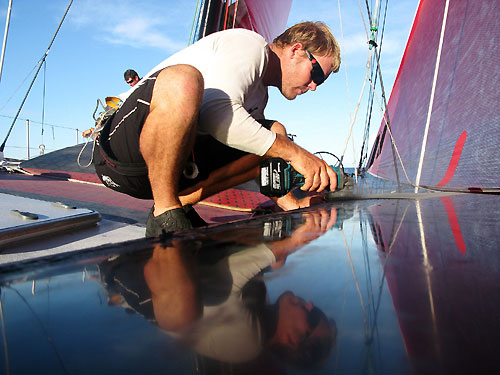Casey Smith making repairs, onboard PUMA Ocean Racing, on leg 5 of the Volvo Ocean Race, from Qingdao to Rio de Janeiro. Photo copyright Rick Deppe / PUMA Ocean Racing / Volvo Ocean Race.