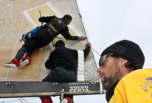 Jordi Calafat and Pable Arrarte repairing the mainsail, earlier on leg 5 of the Volvo Ocean Race, from Qingdao to Rio de Janeiro. Photo copyright Gabriele Olivo / Telefonica Blue / Volvo Ocean Race.