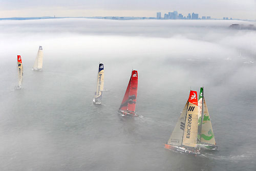 The fleet, covered in fog in the Boston in-port race at Fan Pier. Photo copyright Rick Tomlinson / Volvo Ocean Race.